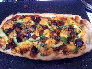 BBQ-ed Tofu Pizza, homemade sauce, avacados, carmelized onions, tofu, and a little aged cheddar and green onions.